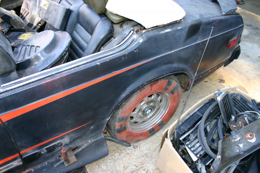 Image of loose parts in boxes and in the car.